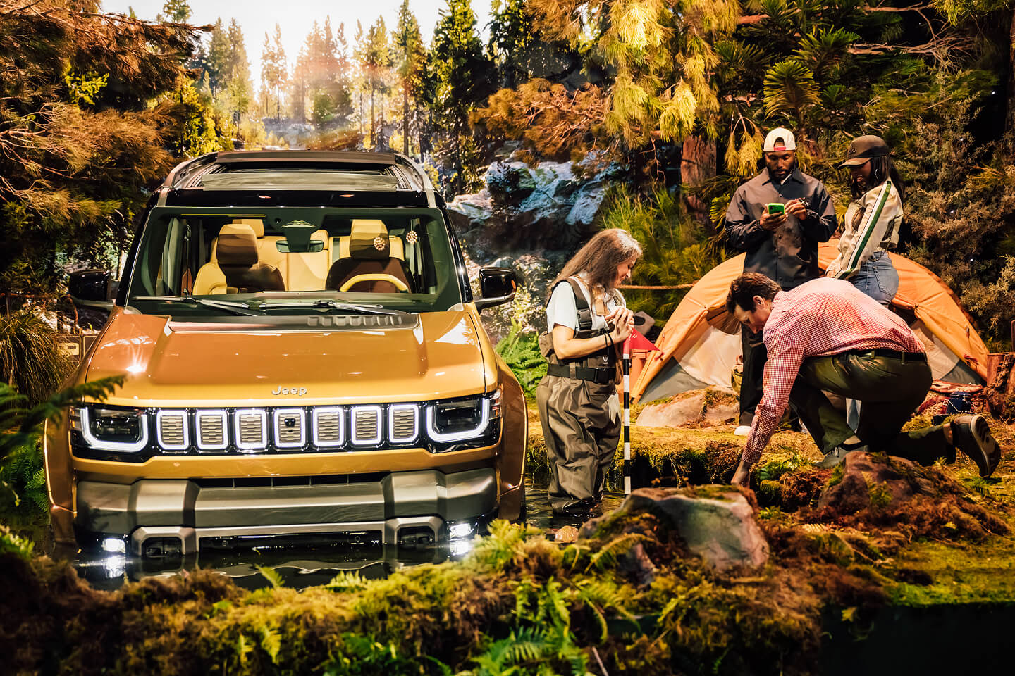 Gold Jeep Recon SUV in a forest-themed brand activation set at the Jeep Recon reveal