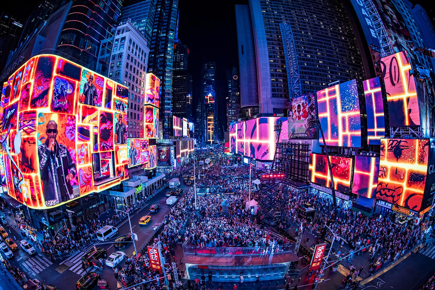 Aerial night view of the Fortnite Chapter 2 Remix launch takeover in Times Square, with crowds and glowing screens