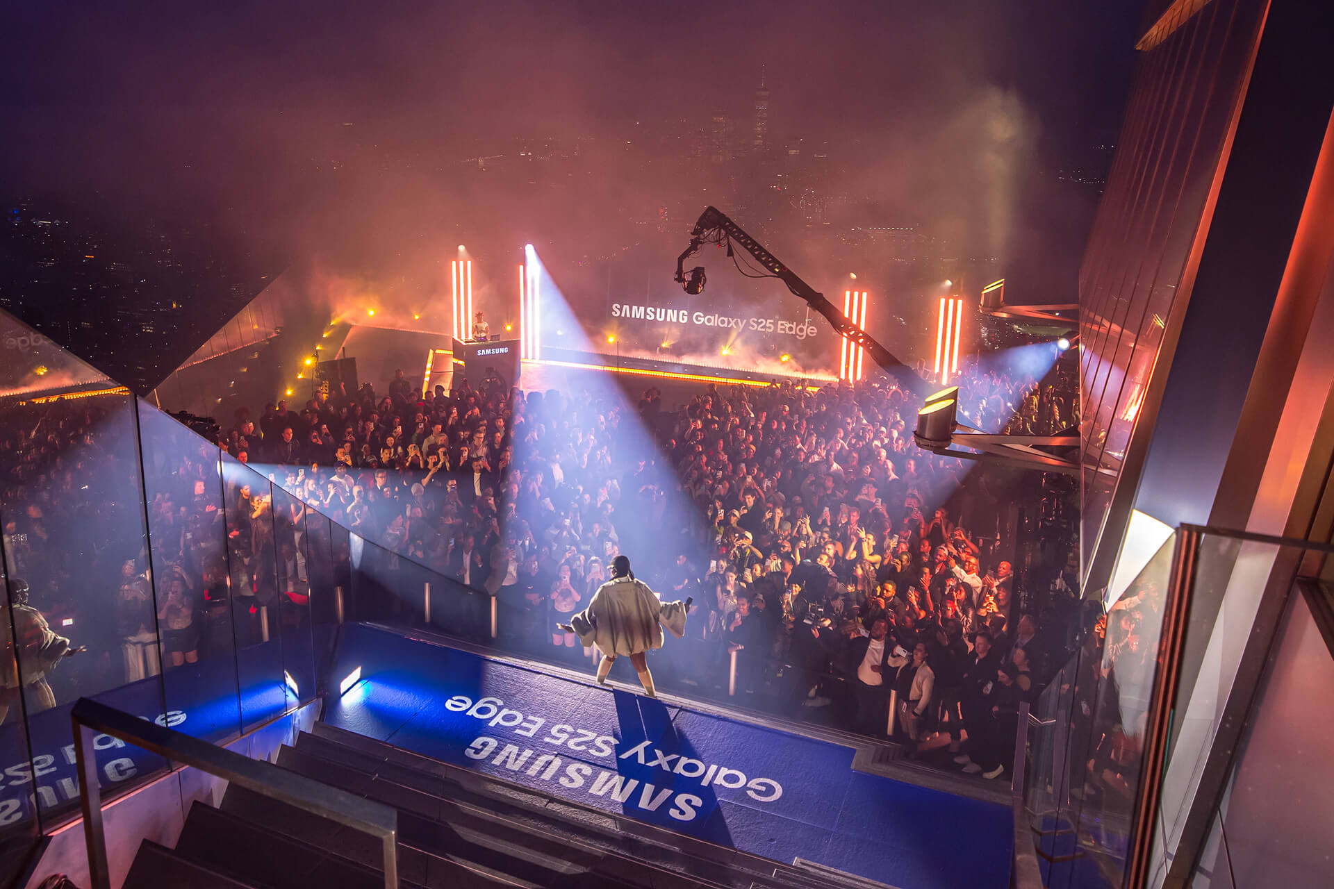 Times Square at night with giant screens and crowds during a broadcast event