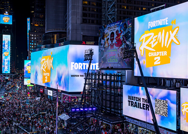 Fortnite Remix Chapter 2 billboards and Watch the Trailer QR code above a packed Times Square