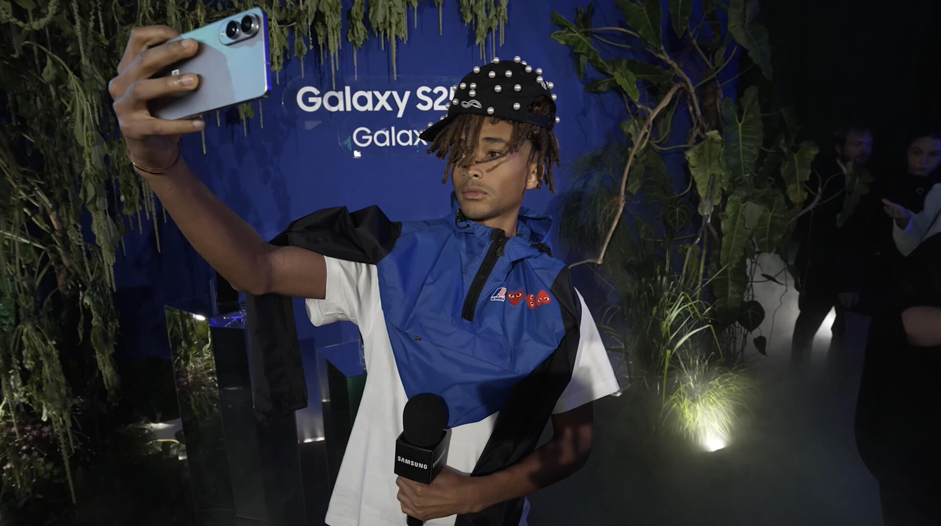 Guest takes a selfie holding a phone at the Samsung Galaxy S25 Edge launch jungle set