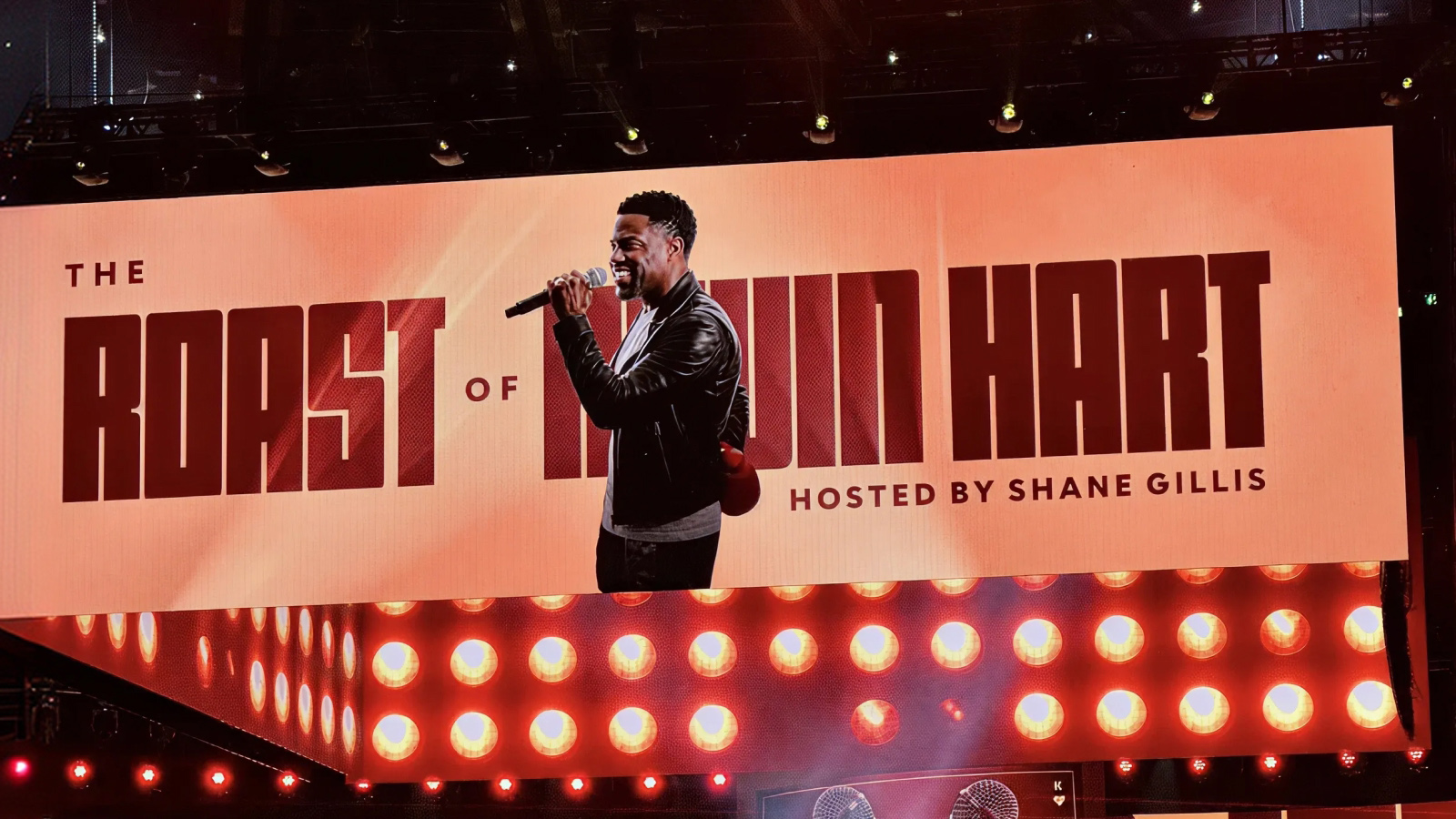 The Roast of Kevin Hart LED stage screen showing Hart with a mic, hosted by Shane Gillis