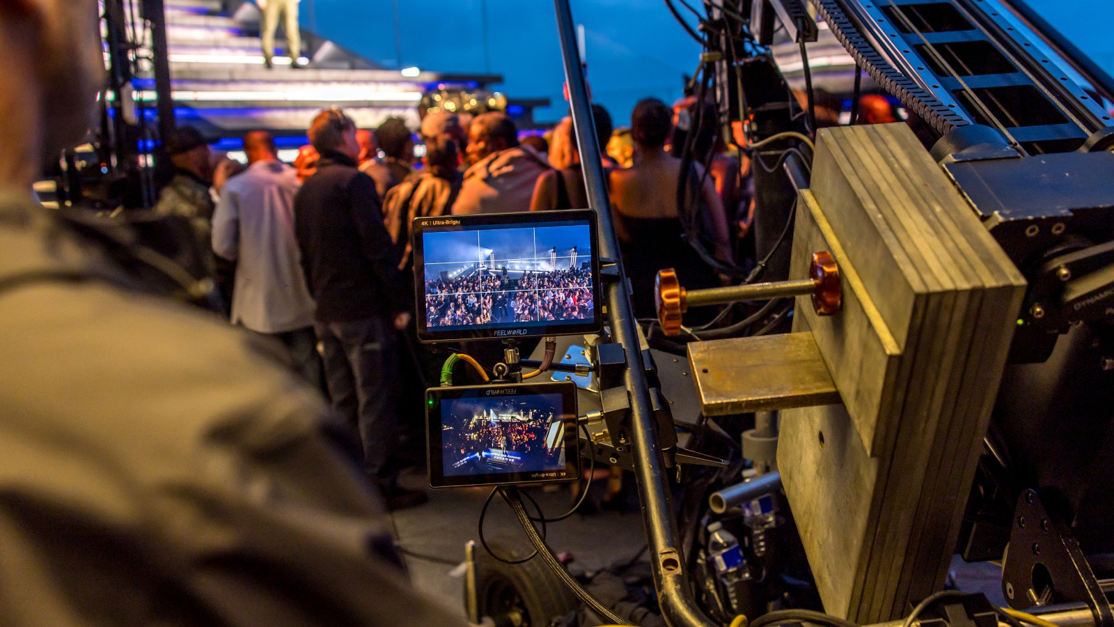 Camera dolly with 4K monitors framing a crowd during a live broadcast production