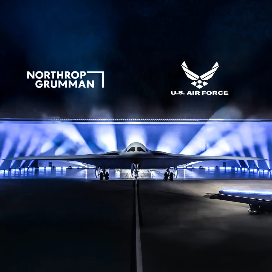 Northrop Grumman and U.S. Air Force stealth bomber reveal under blue light at a launch event