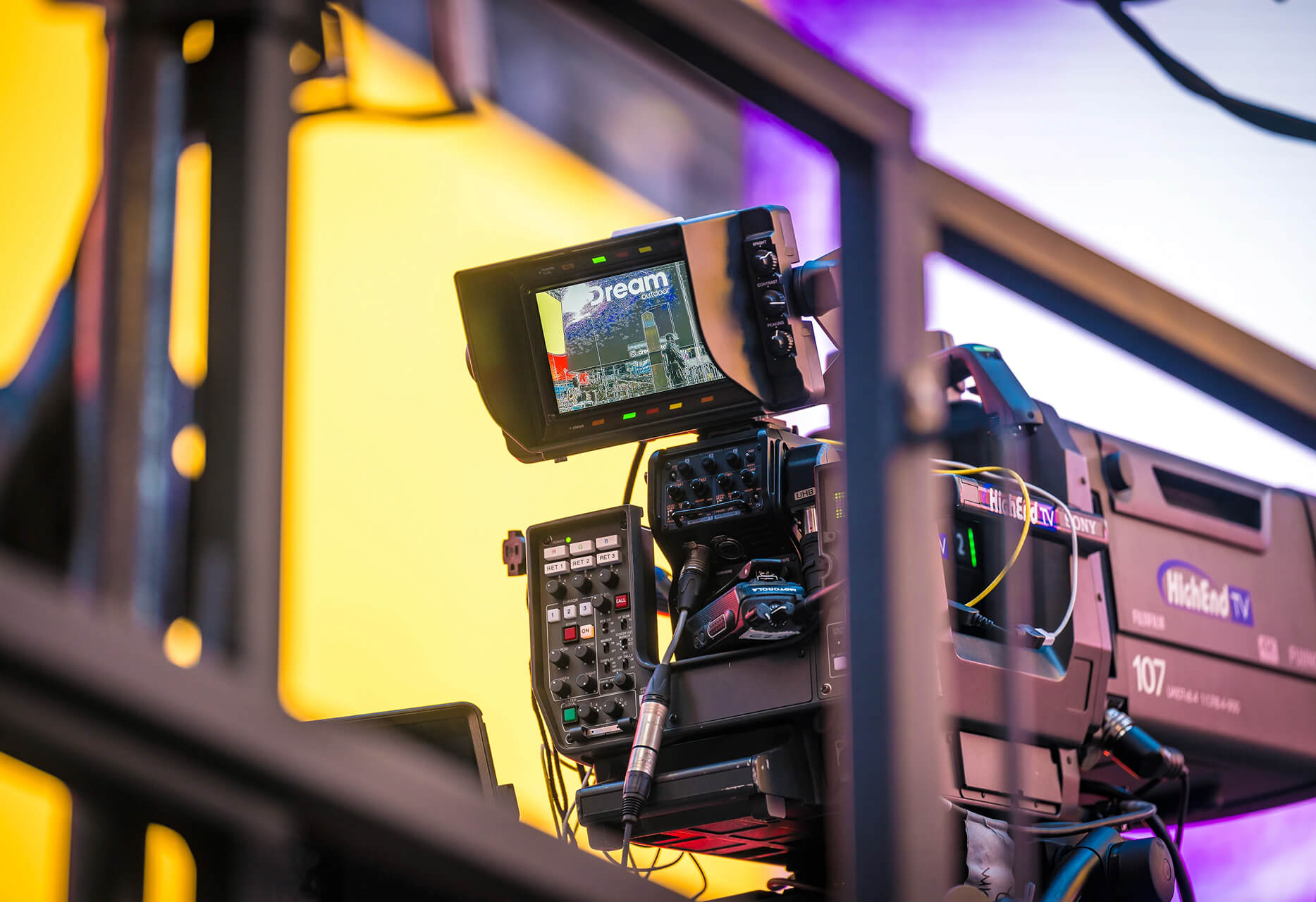 Broadcast Sony studio camera with viewfinder monitor capturing a stadium crowd feed
