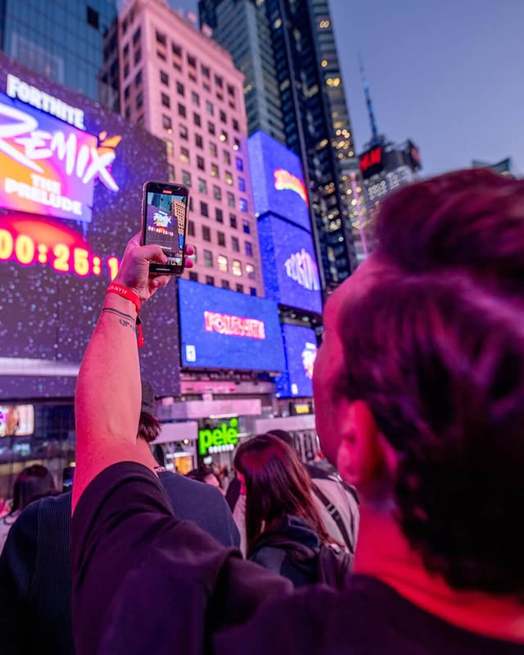 Fan films Fortnite Remix countdown on phone amid Times Square crowd at the Chapter 2 launch
