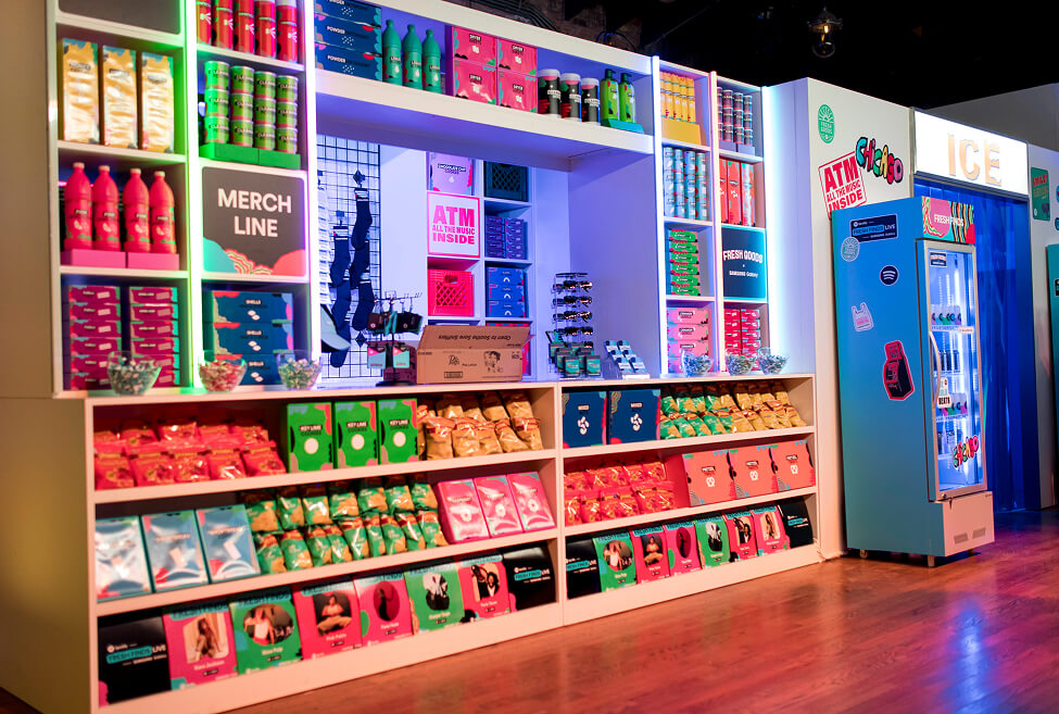 Colorful bodega-style merch shelves and branded fridge at Spotify Fresh Finds activation