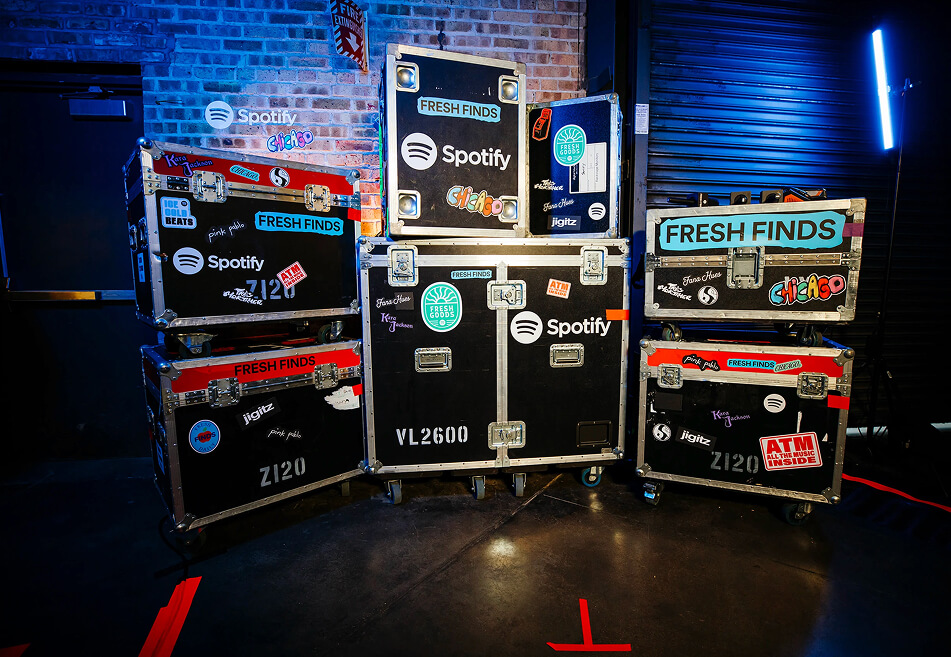 Stacked Spotify Fresh Finds flight cases plastered with tour stickers backstage in Chicago