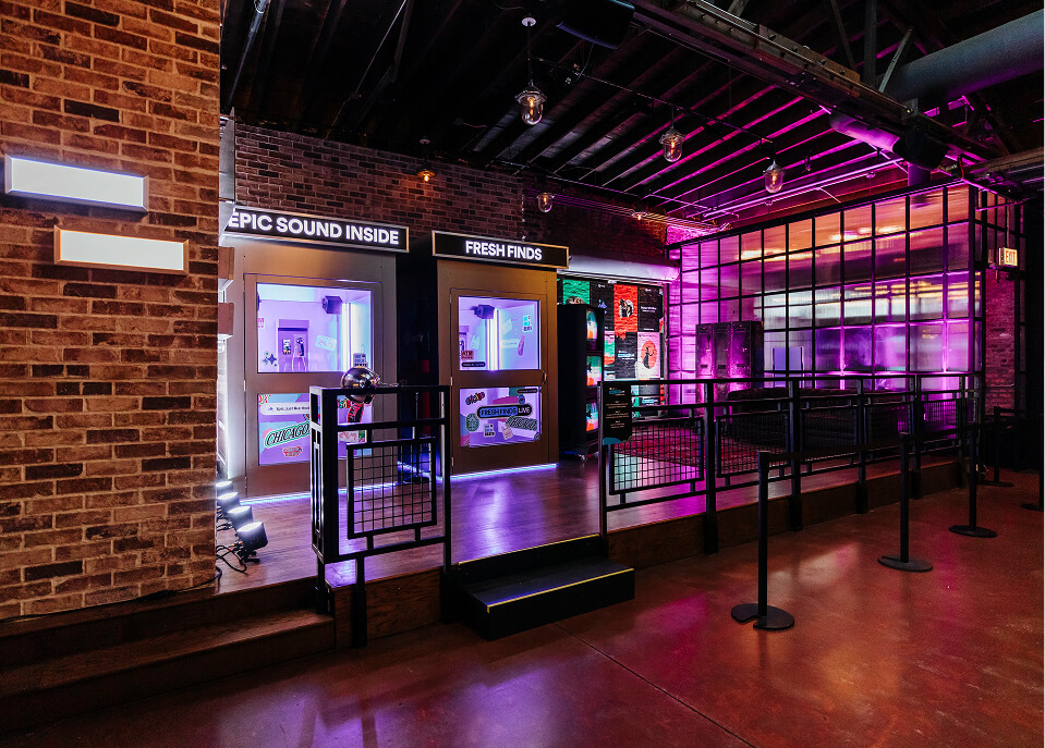 Bodega-themed Fresh Finds display windows with signage and velvet rope queue at Spotify activation