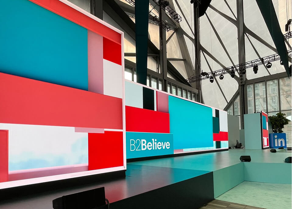 Angular red and teal LED stage set with B2Believe branding at LinkedIn B2Believe event