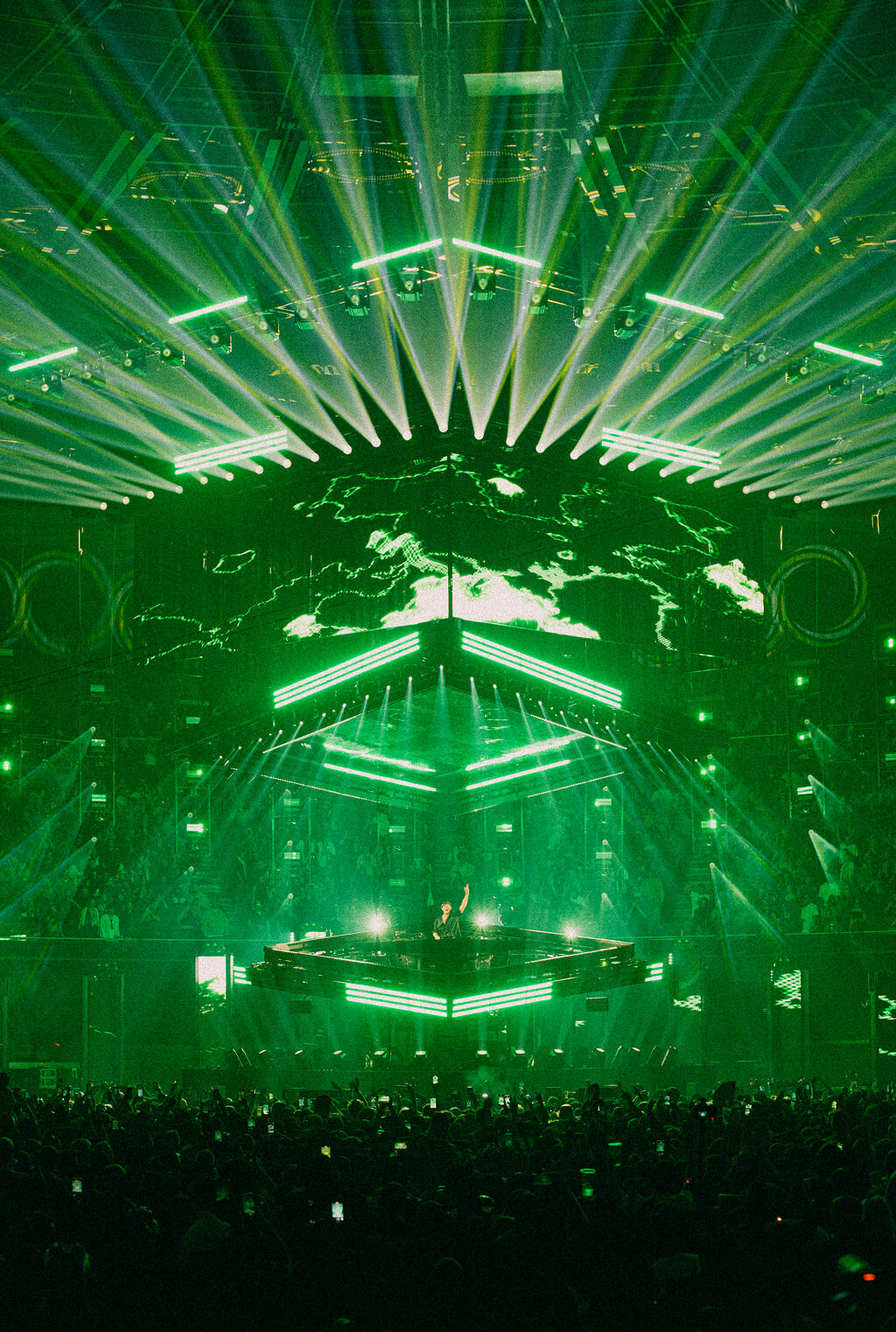 John Summit DJing under fanned green lasers on the Comfort in Chaos Tour