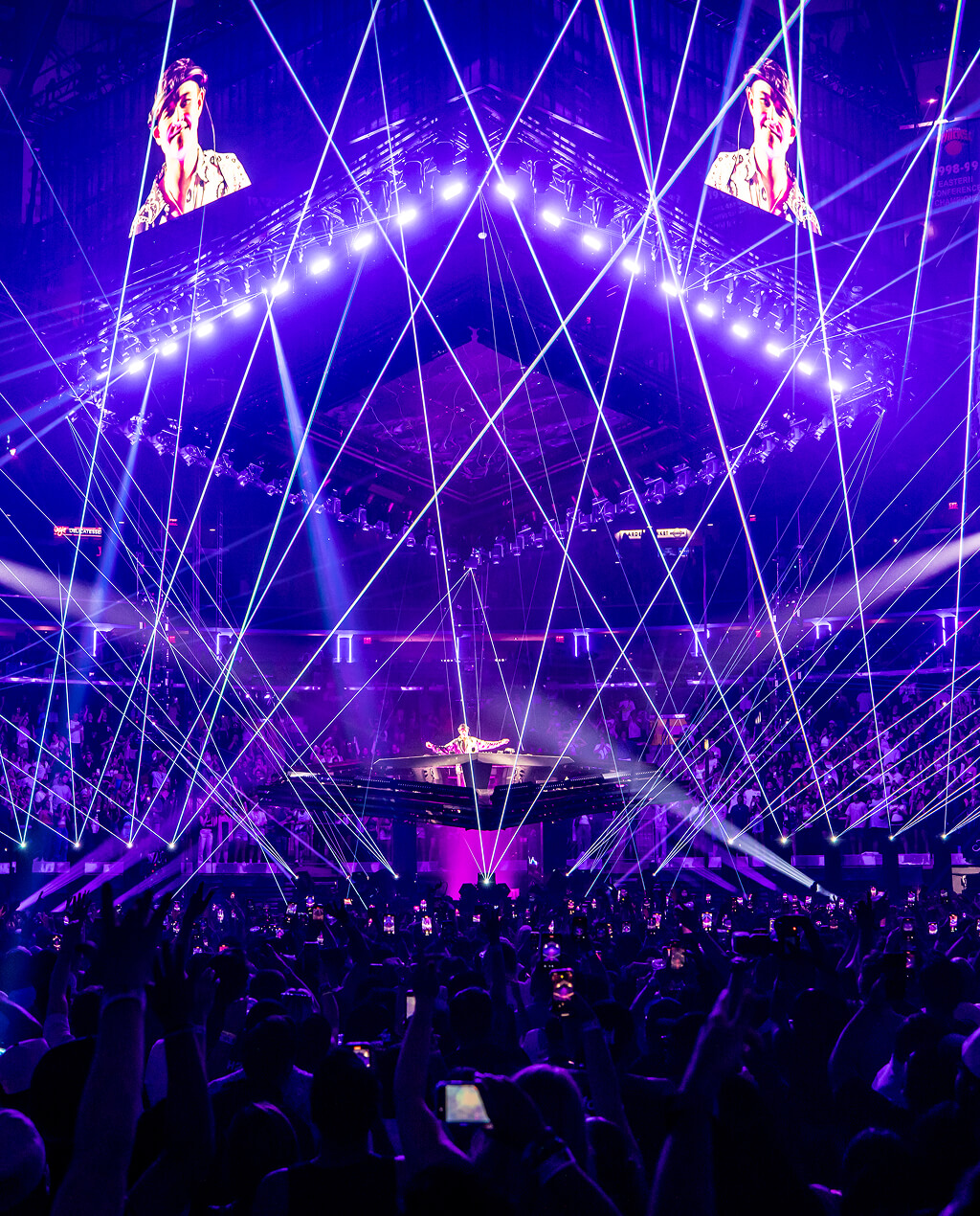 Purple laser web over the crowd and centre stage on the Comfort in Chaos Tour