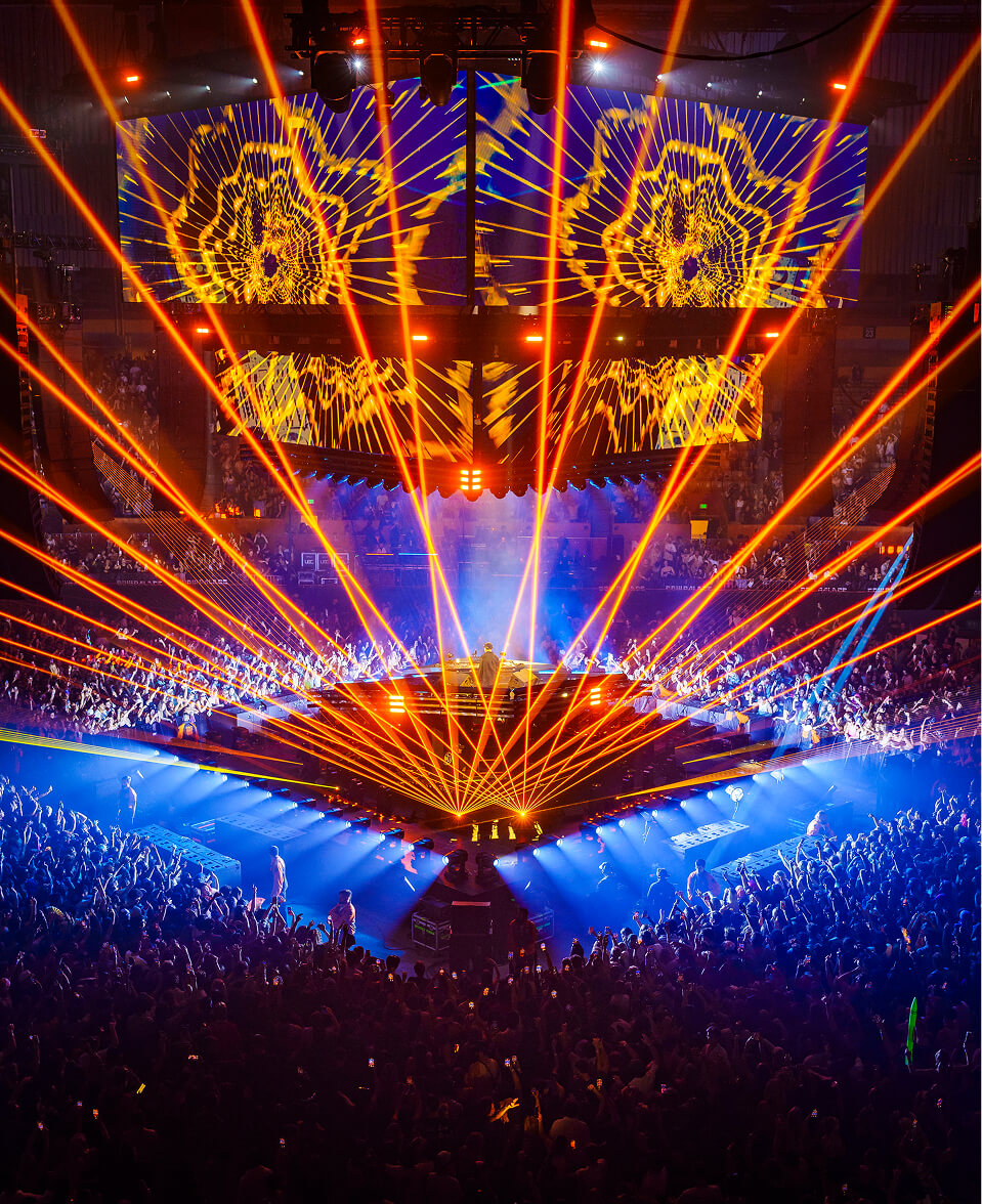 Orange lasers fanning across a packed arena on John Summit's Comfort in Chaos Tour