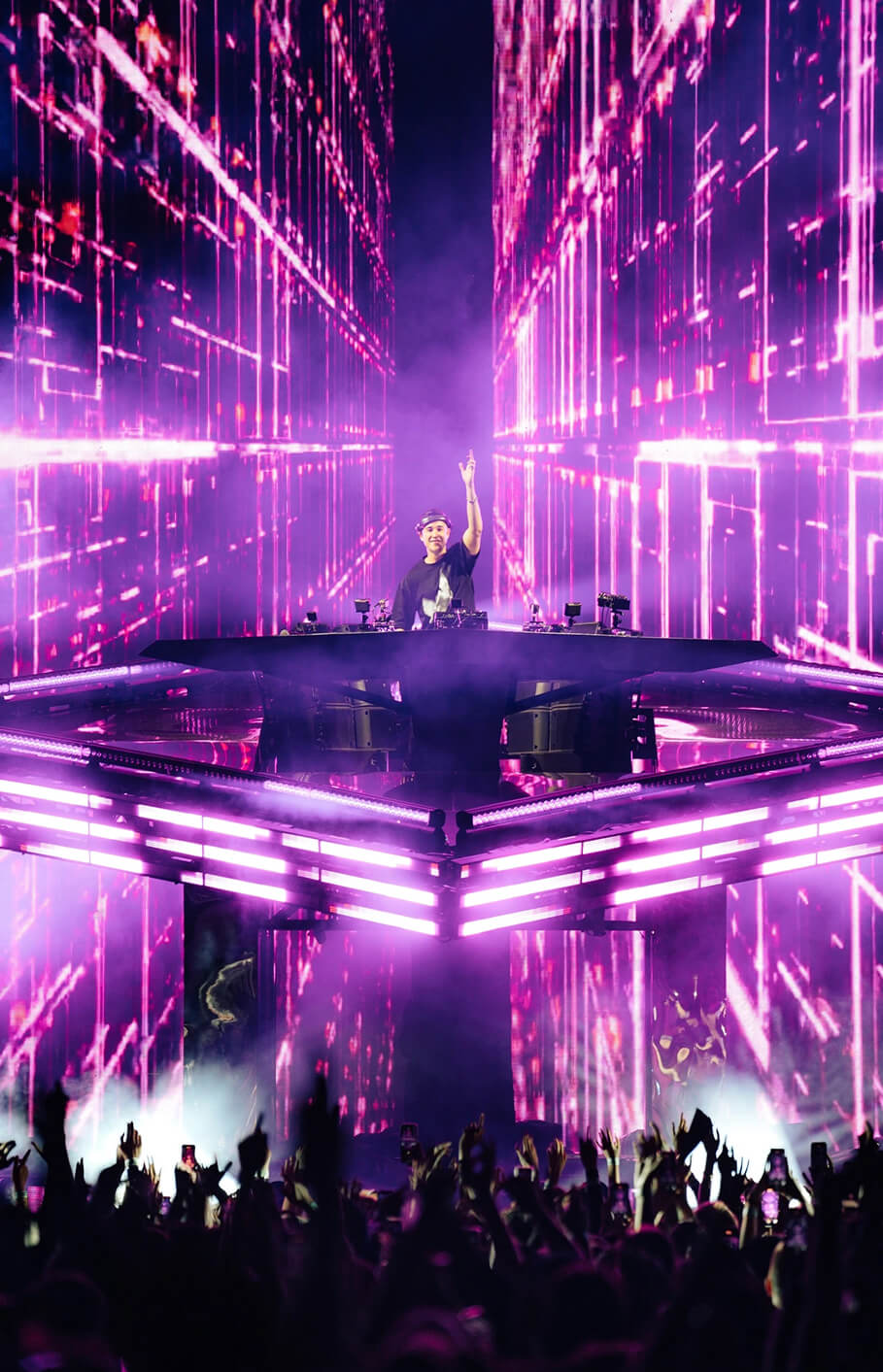 John Summit DJing inside towering pink LED walls on the Comfort in Chaos Tour