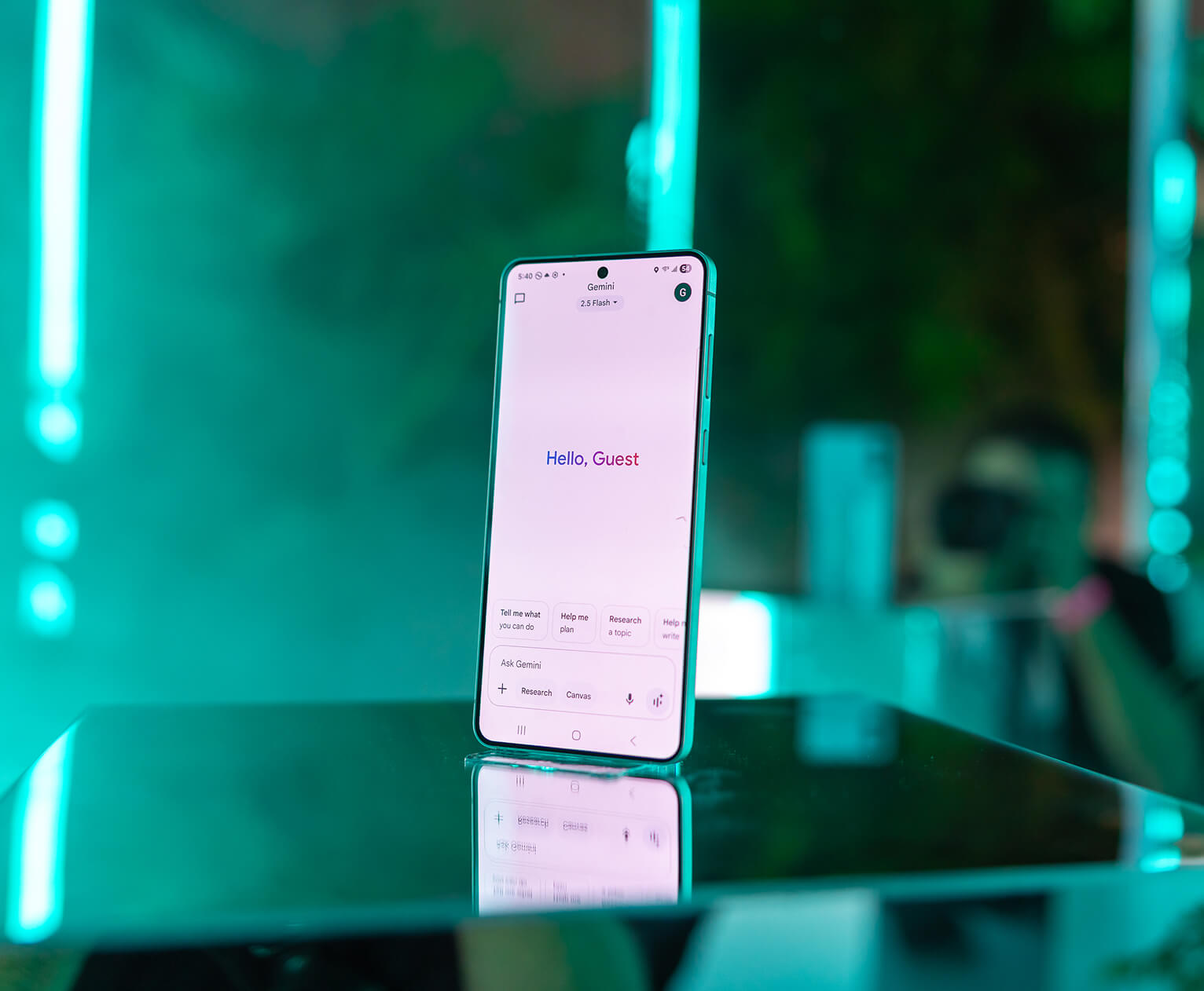 Samsung Galaxy S25 Edge showing the Gemini assistant, mirrored on glass under teal neon lighting