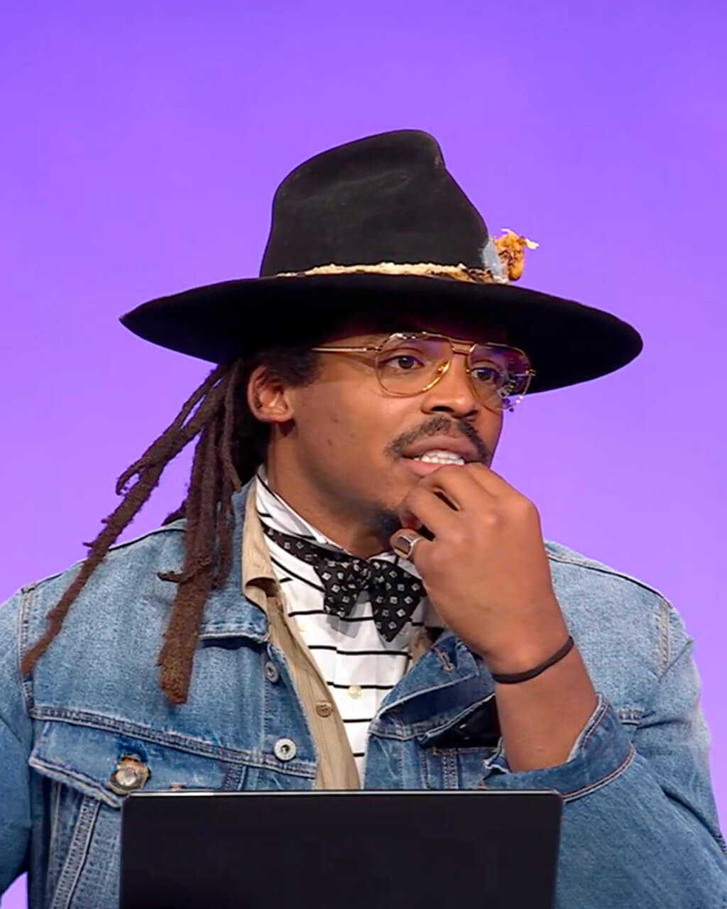 Panelist in cowboy hat and denim jacket thinks on the NFL Ultimate Fantasy Draft set