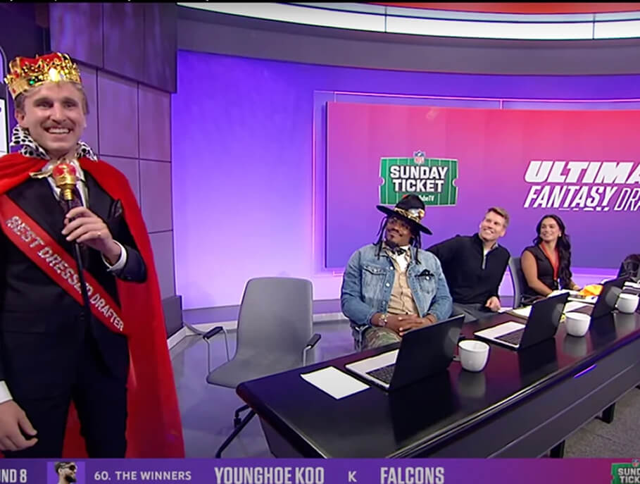Best Dressed Drafter in crown and cape beside the NFL Ultimate Fantasy Draft studio panel