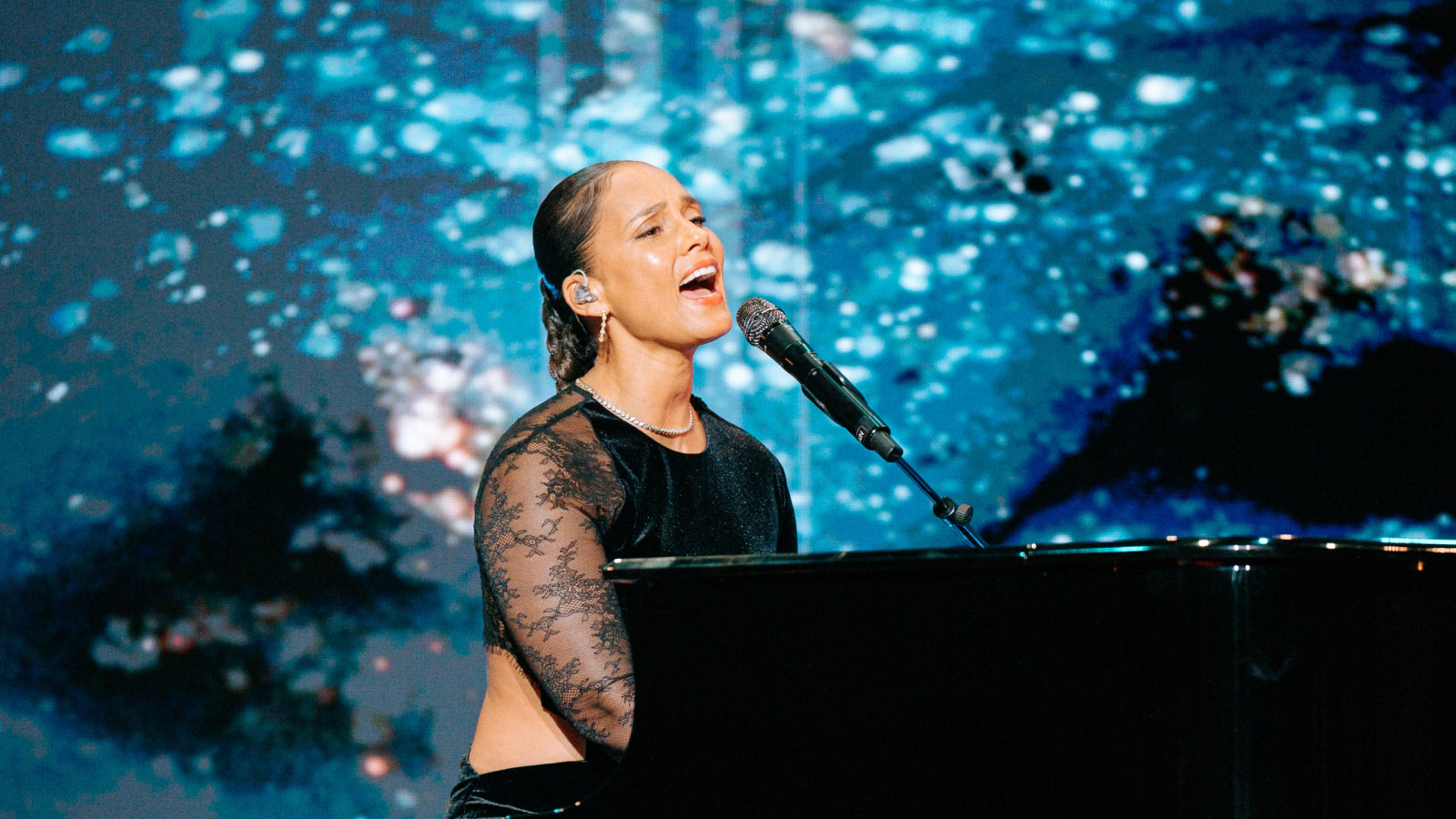 Alicia Keys performing at grand piano during Evening of Impact gala