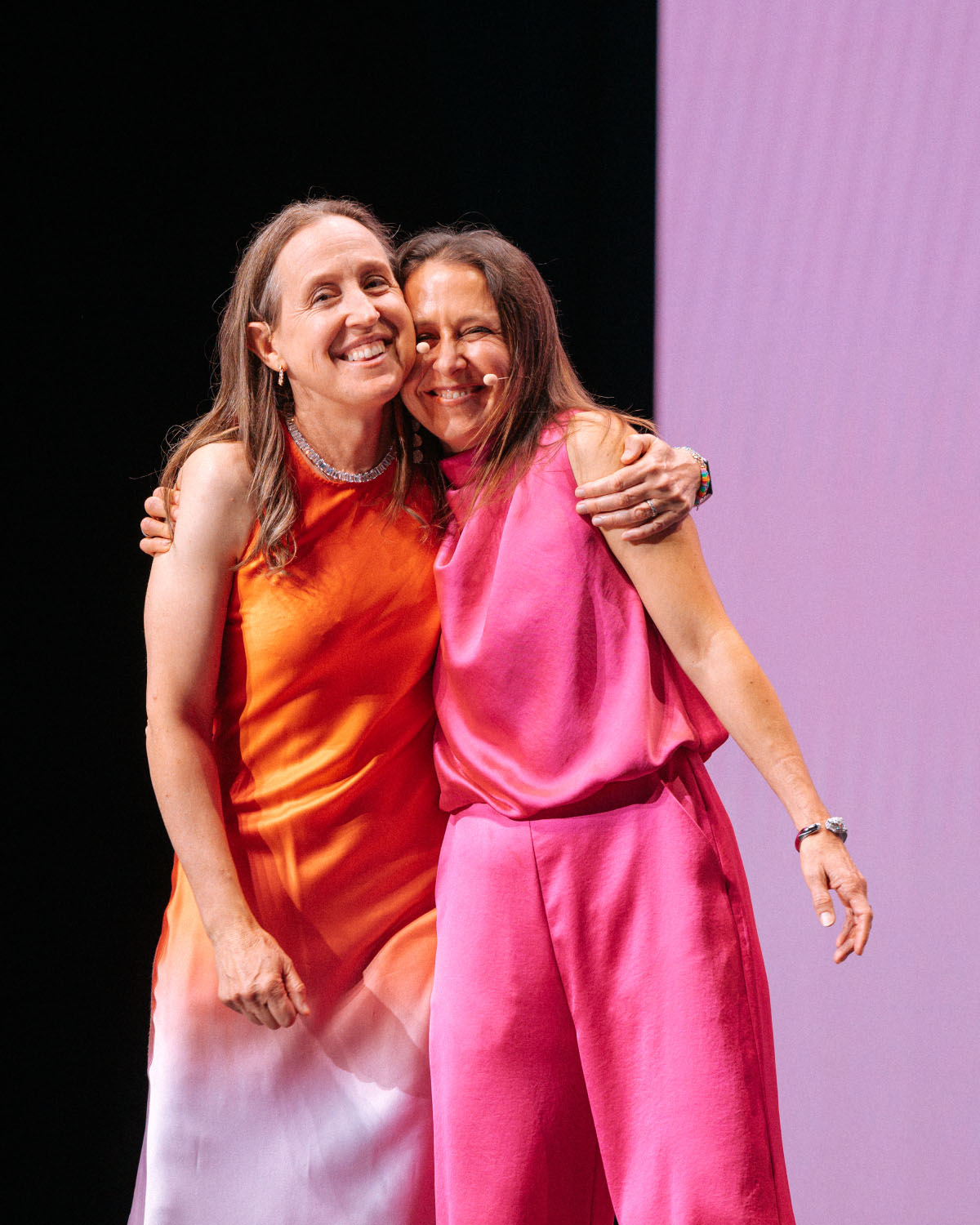 Susan's sisters embracing on stage at Evening of Impact gala
